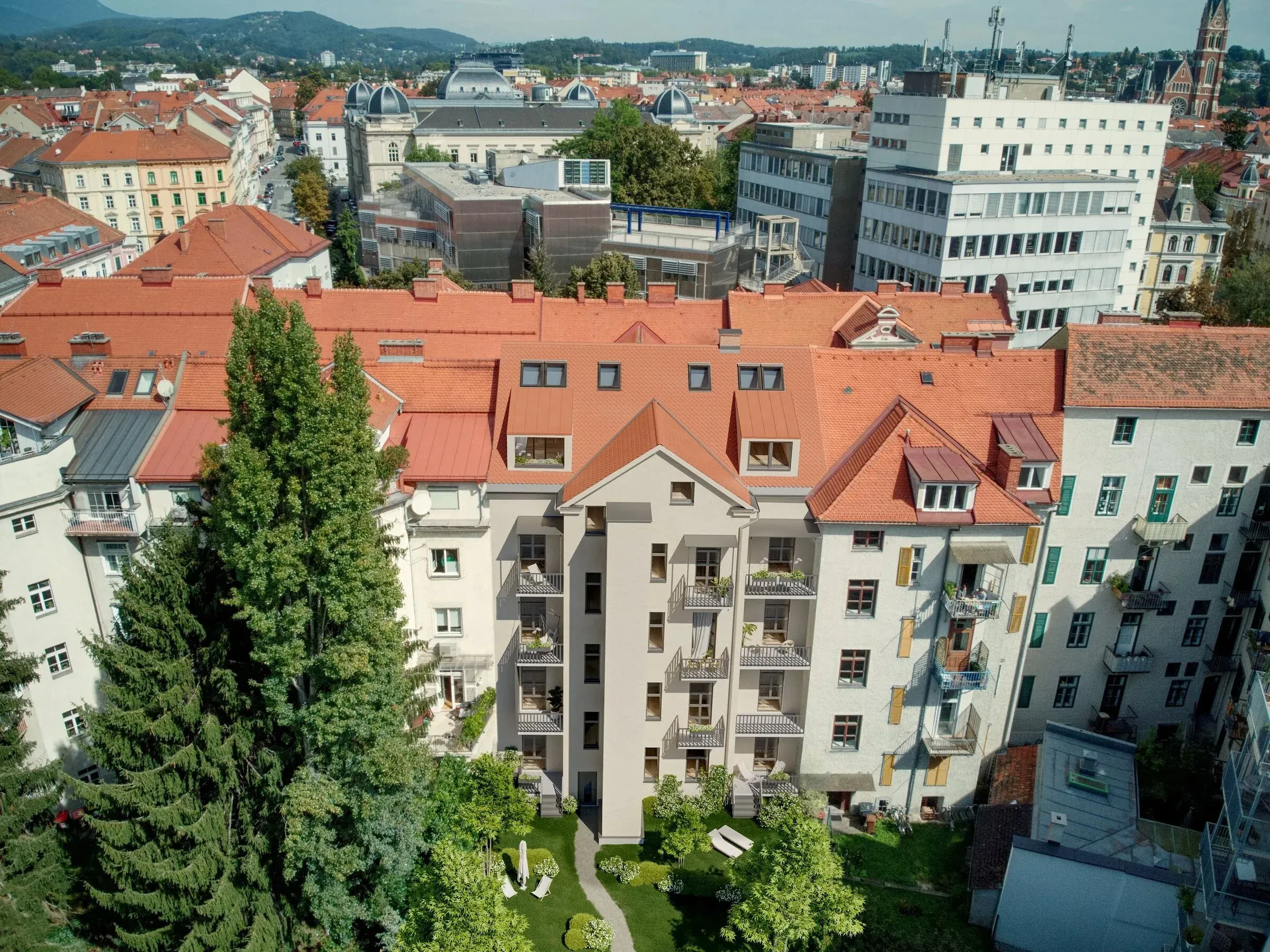 Mandellstraße 18 Graz — drone shot courtyard side with roof terrace and city centre skyline
